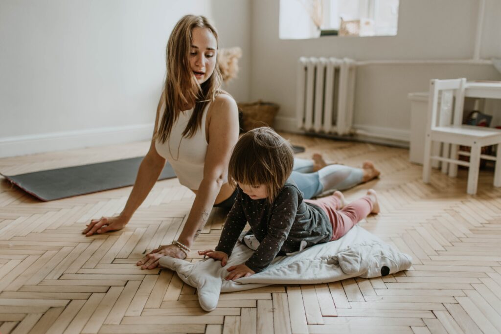 Woman and child doing stretching exercises together. Mindset Shifts to add Movement to your day